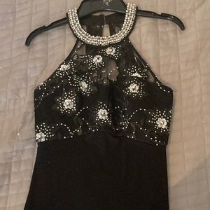 Black formal maxi dress. Has leg slit, sequenced halter top, and exposed back.